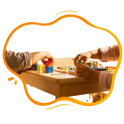 Children’s hands arranging wooden blocks during hands-on preschool learning at Aadhaarshila Global School Jhunsi